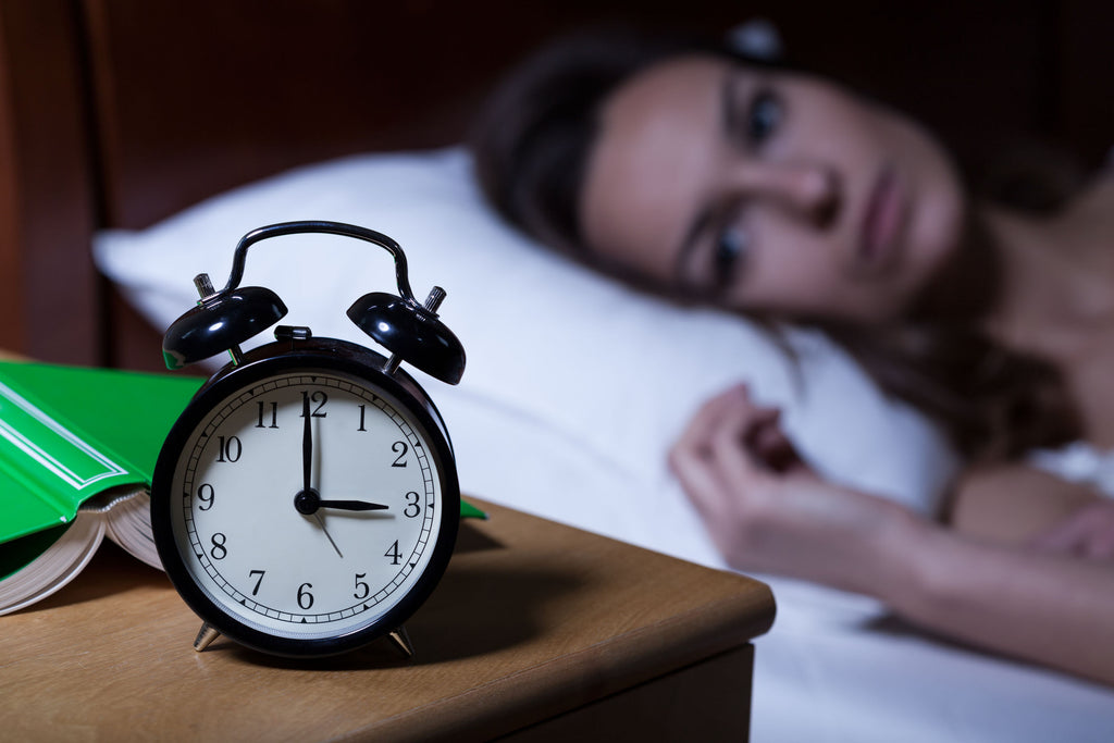 How much cardio should I do: A woman lies in bed awake