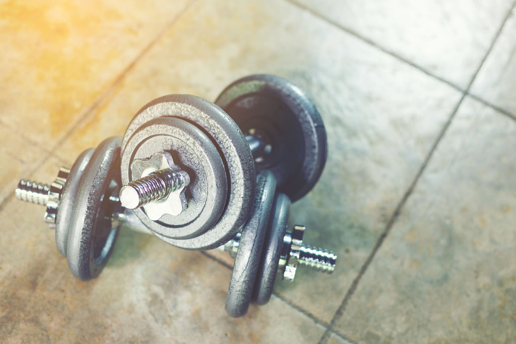 Set of dumbbells sitting on kitchen floor