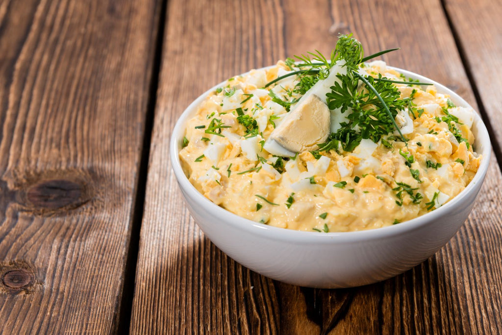 Bowl of egg salad resting on table