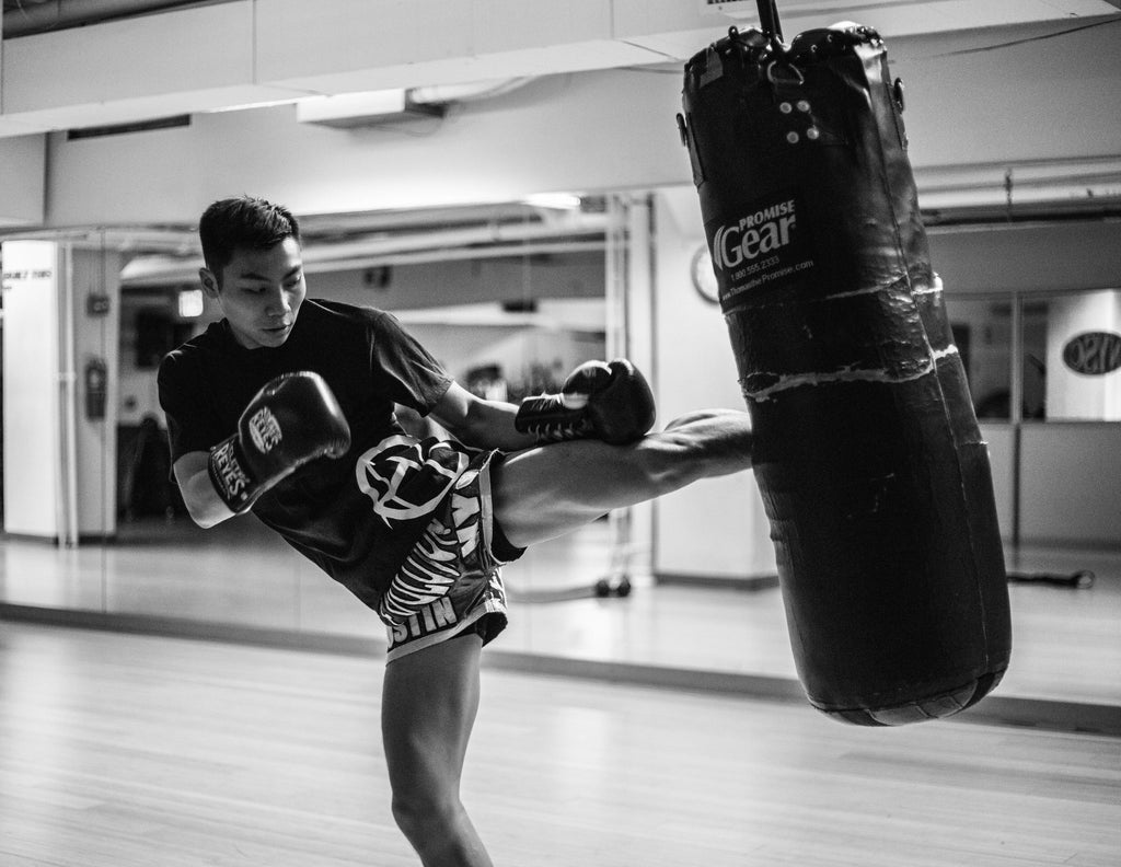 kickboxer training in a gym on a bag
